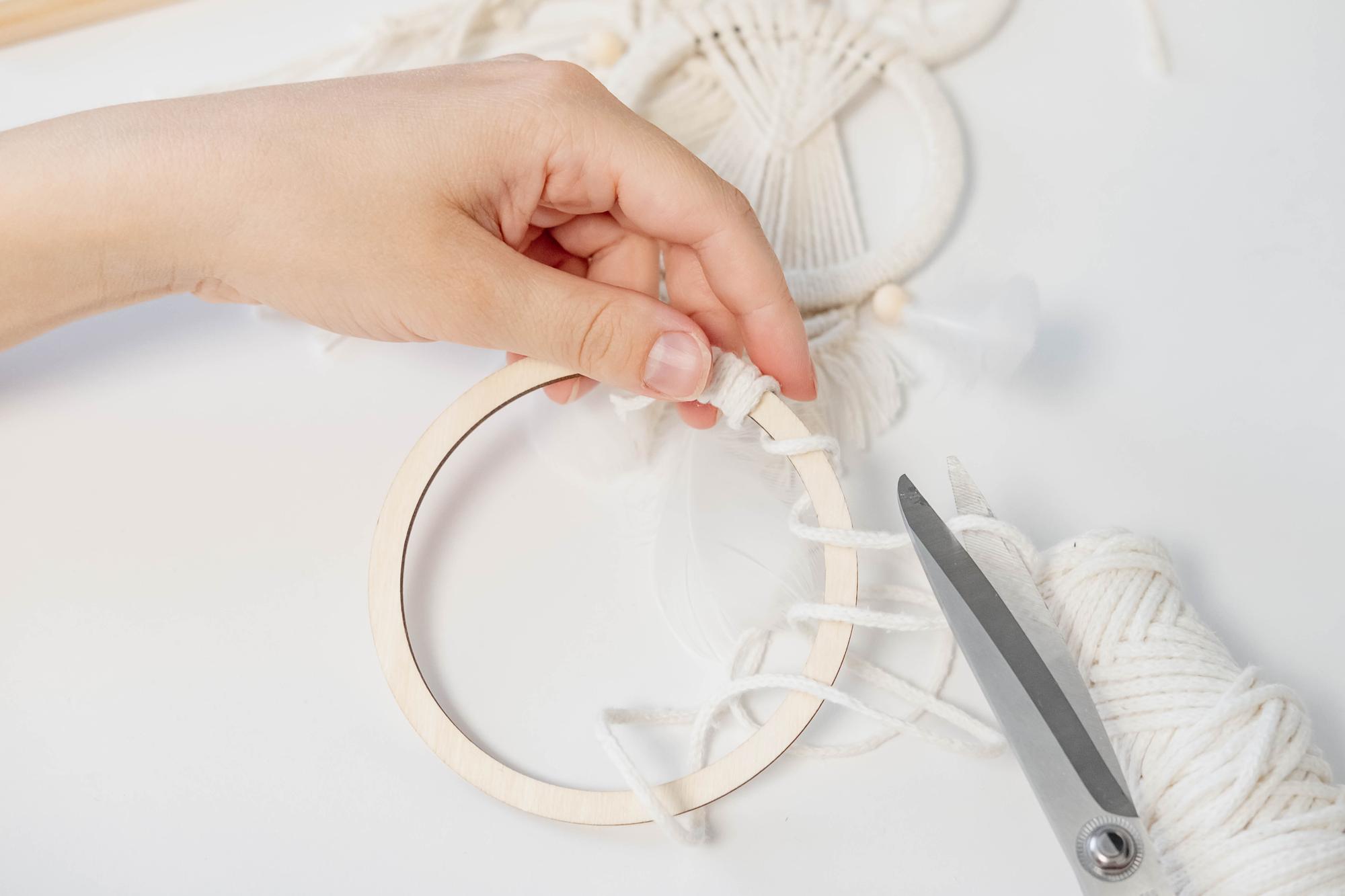 artist hands stitching embroidery hoop